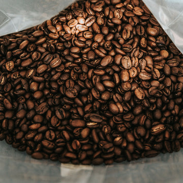 Premium Willow and Bloom Coffee beans in a rustic jar for easy access