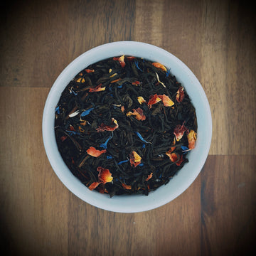 A cup of Willow & Bloom Coffee filled with freshly brewed coffee and aromatic steam rising.